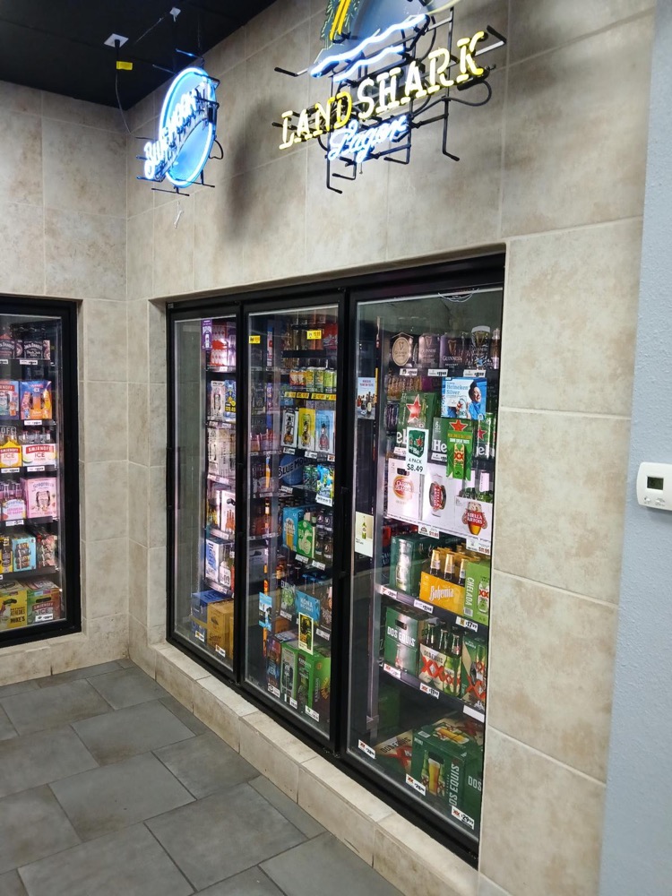 Express 64 frozen beverage section with variety of cold drinks and refrigerated products